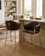 Counterheight bar stools in dark brown espresso faux leather with gold chrome legs and ring handle