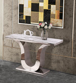 White marble console table with stainless steel U-shaped base, styled in modern home interior