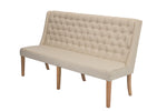 A tufted upholstered dining bench with a beige-colored fabric and rustic wood legs