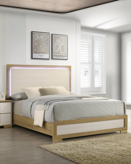 A modern light wood and cream bed frame with a built-in LED backlighted headboard, styled in a bright, contemporary bedroom with white shutters, minimalist wall art, and a neutral striped bedding set.