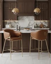 Counterheight bar stools in caramel brown faux leather with gold chrome legs and ring handle