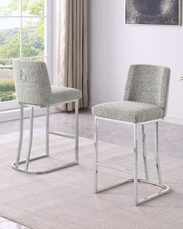 Two modern bar stools with textured light gray bouclé teddy upholstery and chrome metal frames.