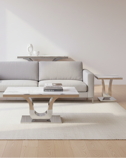 Three-piece white marble and stainless steel coffee table set with curved chrome base
