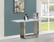 Marble console table with rectangular chrome slatted base against blue wall.
