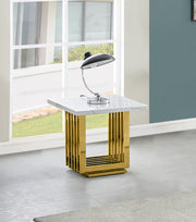 White marble end table with square gold steel base next to window