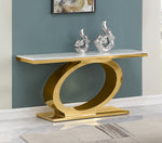 Modern white marble console table with oval gold stainless steel base and silver abstract decor against teal wall