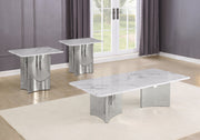 A modern 3 piece coffee set featuring a rectangular coffee table and two matching side end tables with white marble tops and sculptural chrome bases