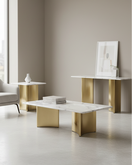 Modern minimalist living room furniture set featuring a white marble coffee table with a sculptural gold base, a matching white marble side table with a gold pedestal base, and a white marble console table with a gold base, styled with a framed print and small vases.