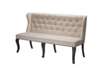 An upholstered bench with a tufted wingback backrest, beige fabric, and dark wood legs.