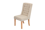 A single upholstered wingback dining chair with a tall, button-tufted backrest, a padded seat, and light natural wood legs