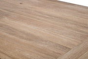 Close-up of a light brown wood grain surface with visible natural texture and a corner edge.